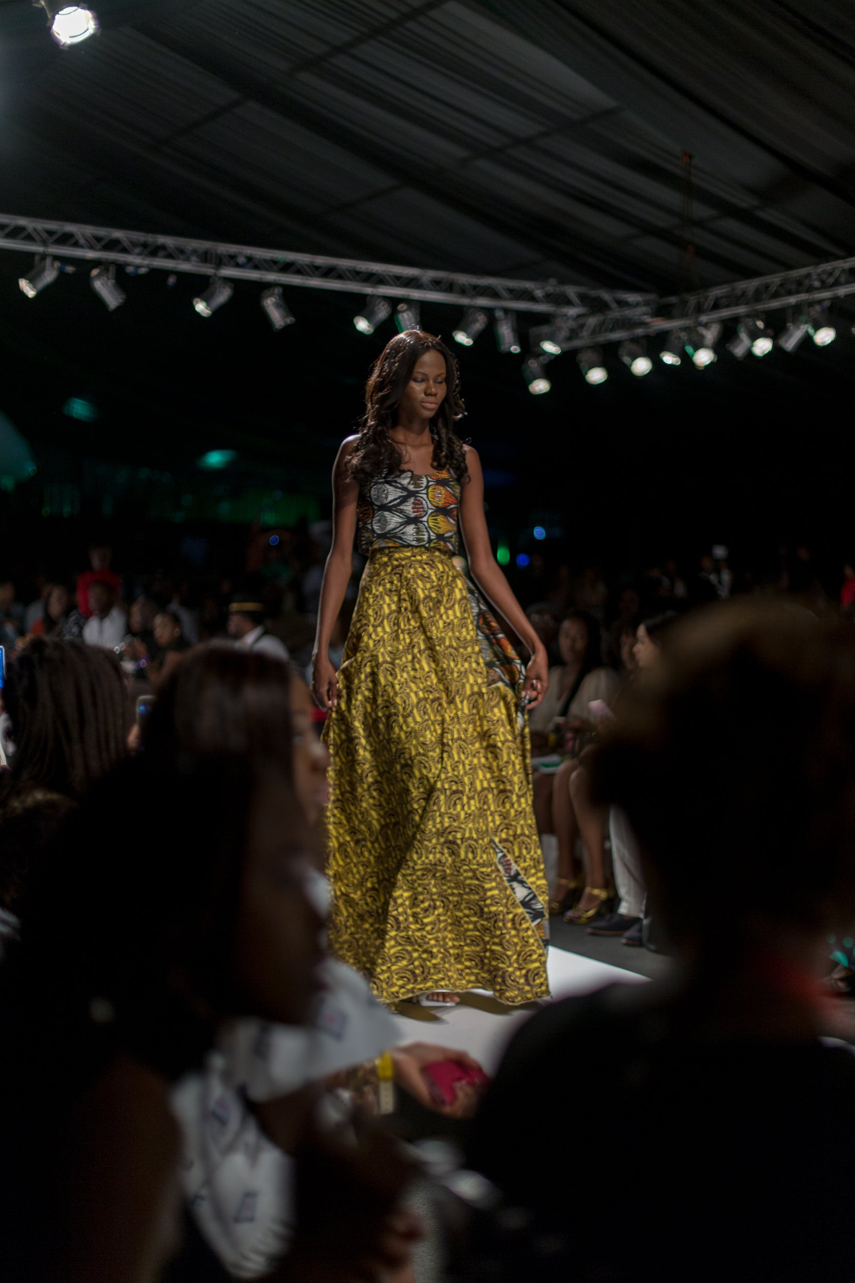 Model wearing bold yellow Ankara wax-print palazzo pants and bodice at Lagos Fashion and Design Week